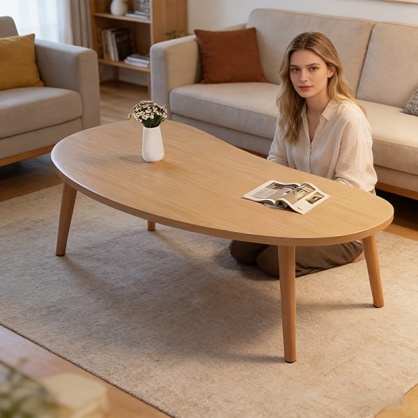 product-fancy-85a3ed02-8d9d-4b38-9298-5152626b7130 Natural Wood Grain Oval Coffee Table, Irregular Solid Wood Top Shows Unique Beauty. Slim Legs Create Lightweight Visual. Cozy Companion for Living Room Reading Nook. Holds Vase And Magazines Displaying Lifestyle. Modern Minimalist Home Core Piece