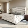 product-fancy-cfb15c3d-9bb5-4fae-8007-917c83007d90 Handcrafted Velvet Bed Frame Featuring a Wingback Headboard, Adorned with Button Tufting And Nailhead Accents, Supported by Wooden Slats.